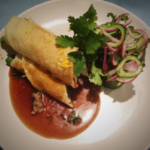Duck filled crepes with orange hoisin sauce with cucumber red onion salad